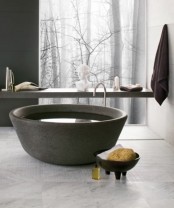 a unique bowl-like stone bathtub is an ultimate solution for a contemporary or minimalist bathroom