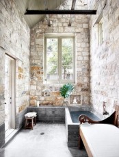 a gorgeous wabi-sabi bathroom all clad with stone and with a brick clad bathtub is a cool idea for an indoor-outdoor space