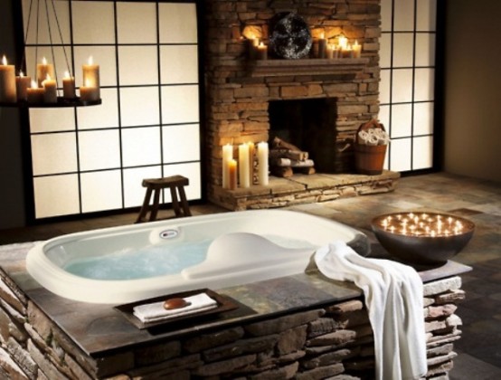 a bathtub and a fireplace clad with decorative stone plus lots of candles that create a mood and an atmosphere a bathtub and a fireplace clad with decorative stone plus lots of candles that create a mood and an atmosphere
